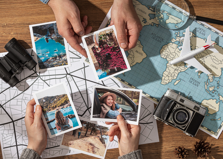 Travel photo prints spread on a world map